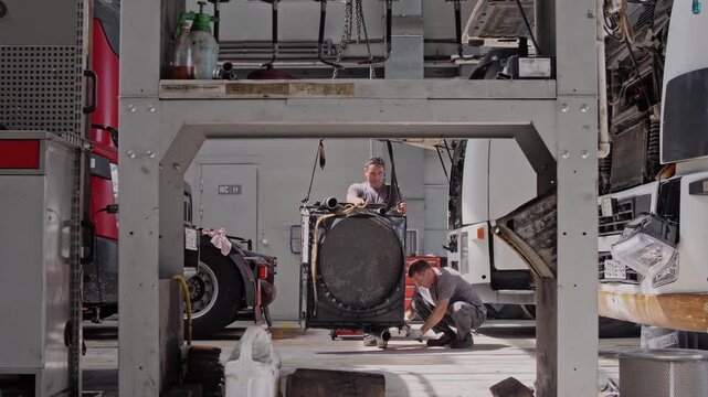 Locksmiths and auto mechanics work at a company that repairs and maintains engines and chassis of cargo vans 