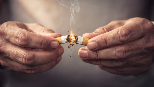 A close-up shot of hands deliberately breaking and crushing a lit cigarette, with smoke and glowing embers visible, symbolizing addiction cessation and new beginnings