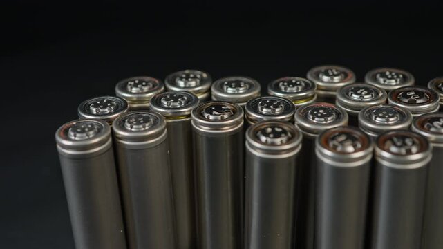 Silver AA batteries type on black matte background as an example of rare earths metals use in magnets, smart devices, electric vehicles and are hard to mine and separate cleanly.
