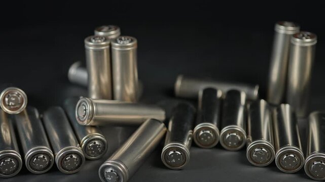 Silver AA batteries type on black matte background as an example of rare earths metals use in magnets, smart devices, electric vehicles and are hard to mine and separate cleanly.