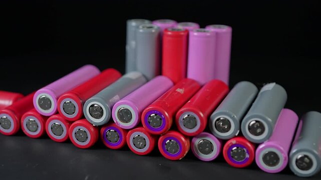 Battery cells extracted from inside assembly of high tech modules. Such as EV electric vehicles, electric e-bikes and computers cordless power parts. Energy storage and tech power.