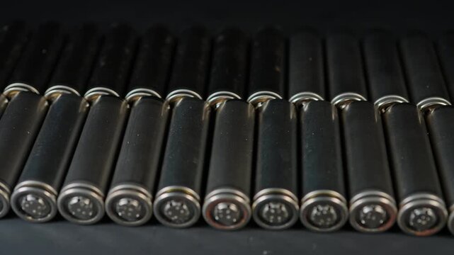 Silver AA batteries type on black matte background as an example of rare earths metals use in magnets, smart devices, electric vehicles and are hard to mine and separate cleanly.