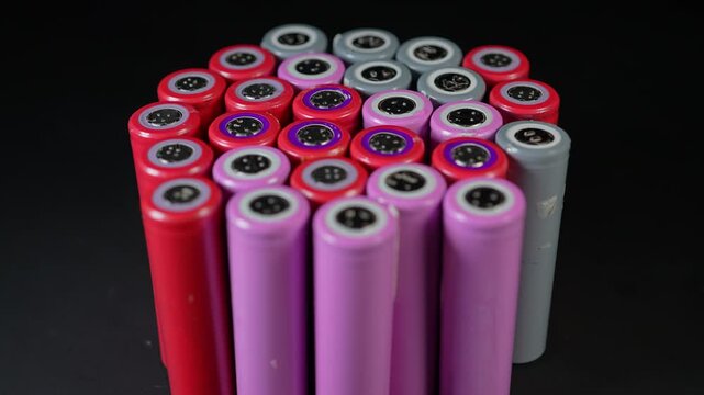 Battery cells extracted from inside assembly of high tech modules. Such as EV electric vehicles, electric e-bikes and computers cordless power parts. Energy storage and tech power.