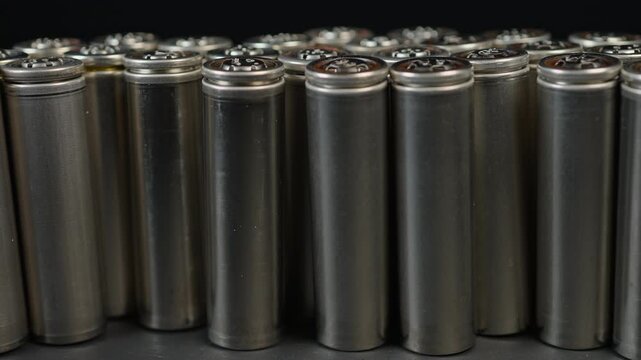 Silver AA batteries type on black matte background. Standard size single cell cylindrical dry battery for EV vehicles and portable electronic devices such as computers and laptop cordless power.