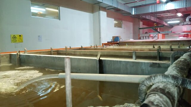 The technician opens the valve and fills the chemical cleaning cabinets with water.
