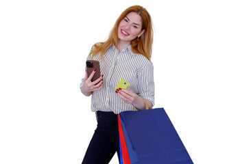 Obraz premium Woman holding phone and credit card, online shopping and paying with shopping bags, enjoying consumerism concept