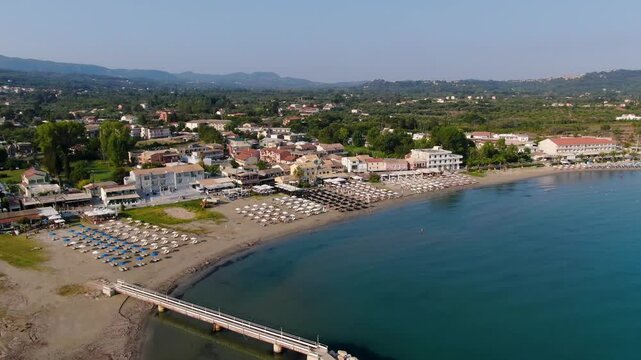 Top down aerial view of turquoise waves crashing on sandy Roda Beach in Corfu Greece capturing crystal clear water and shoreline textures ideal for nature and relaxation travel content