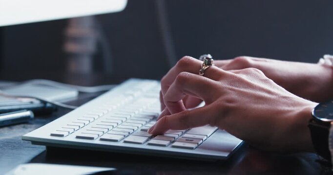 Hands Typing on Keyboard in Modern Office