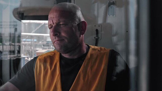Locomotive driver in the cab of a diesel locomotive. Portrait