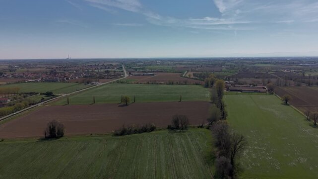 Panoramic Landscape of Fields: Expansive fields stretch towards the horizon under a clear, azure sky, creating a sense of openness and serenity.