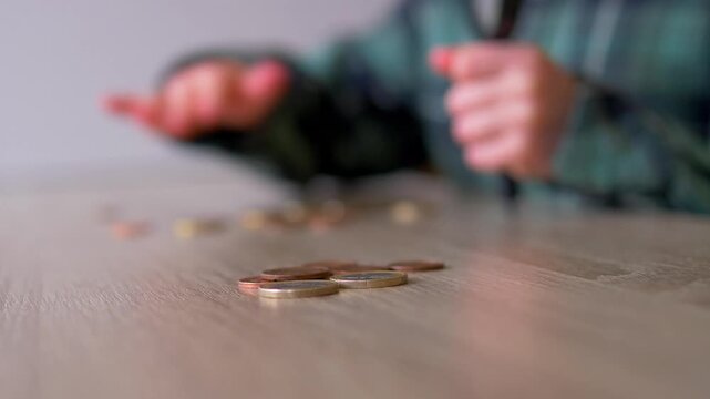Child's Hand Picking Up Gold Coin from Pile, Junior Financial Education and Currency Sorting, Hands-on Money Management and Learning for Kids