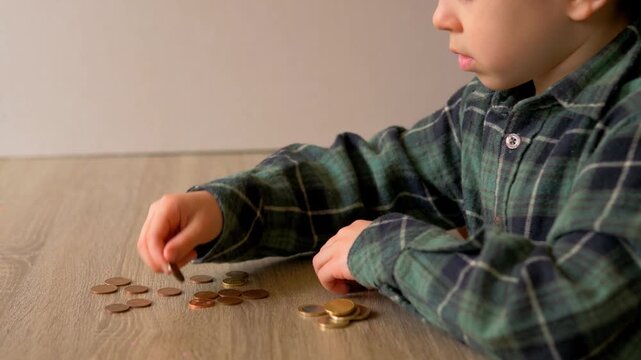 Young Boy Sorting Mixed Euro Coins and Cent Coins on Wooden Table with Focused Concentration &mdash; Euro Currency, Child Financial Literacy, Money Counting and Numeracy Concept