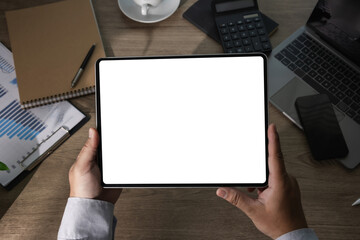 Digital tablet mockup in an office workspace with blank screen for app design, business presentation, finance dashboard, analytics display, marketing report and branded content.