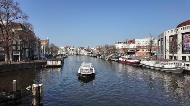 A view down the Amstel canal in the city of Amsterdam on a beautiful day in spring.