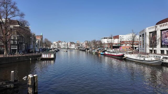 A view down the Amstel canal in the city of Amsterdam on a beautiful day in spring.