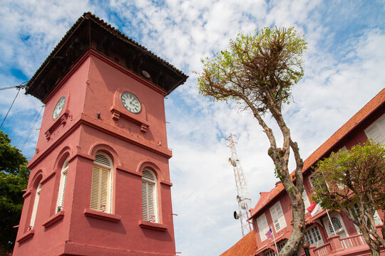 The Red Sentinel: A Monumental Low-Angle View of the Tan Beng Swee Clock Tower in Melaka, Malaysia