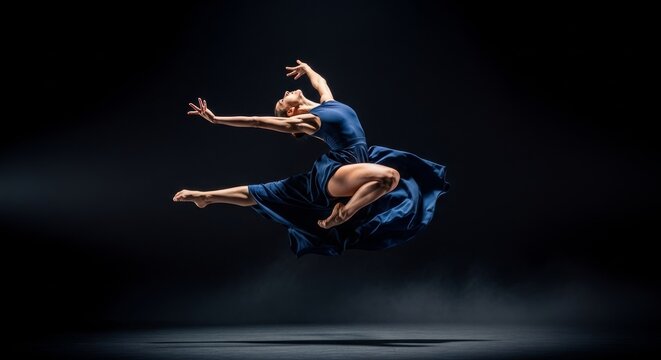Dancer in deep blue dress leaps gracefully on stage