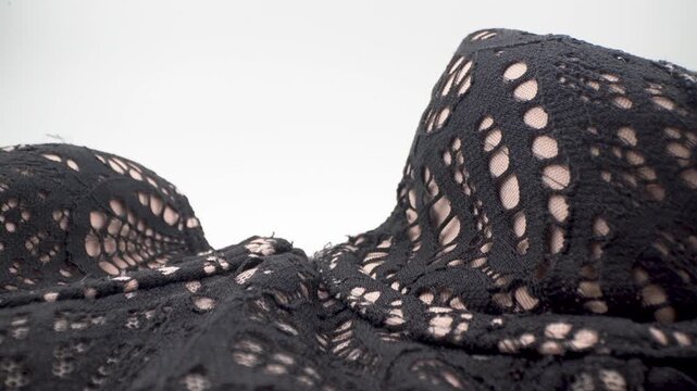 Close up of lace corset bra fabric texture and pattern details.