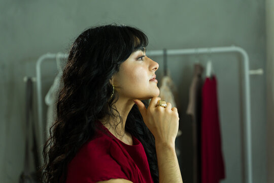 Young woman getting ready backstage, thinking about her upcoming fashion show or event, preparing for work