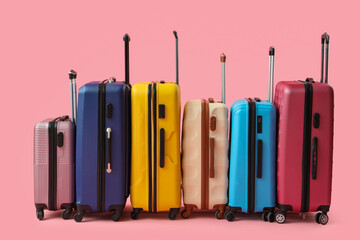 Many suitcases on pink background