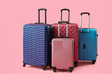 Many suitcases on pink background