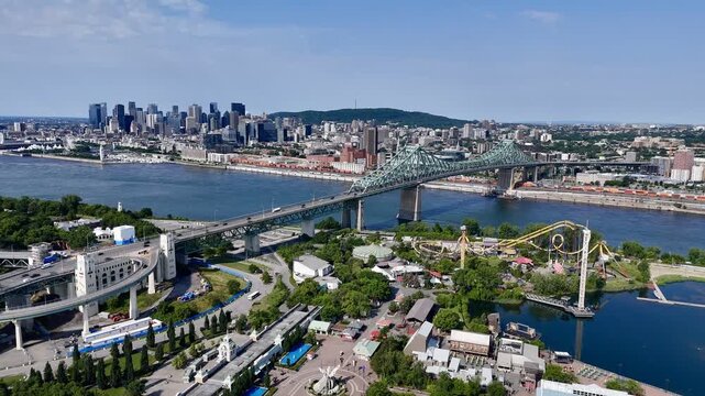 Aerial view of Montreal skyline, Jacques Cartier Bridge and La Ronde amusement island on St Lawrence River. g.