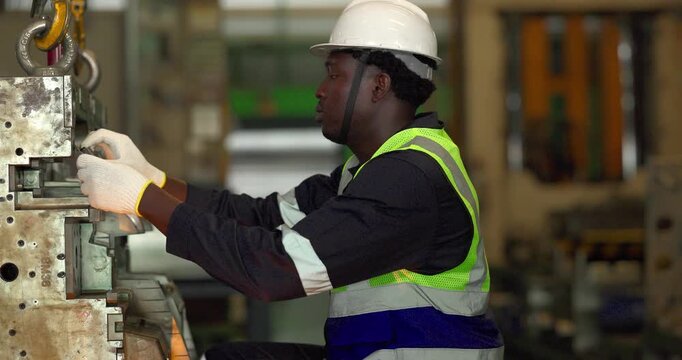 Factory technician uses a vernier caliper to measure a metal component during dimensional inspection in a manufacturing facility, showing quality control, tolerance checks, and process verification.
