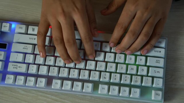 Hands typing on compact white mechanical keyboard