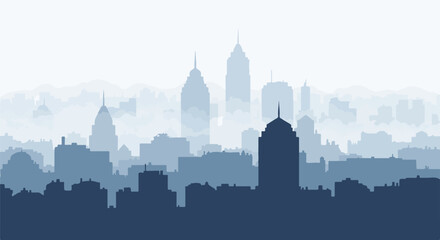 Naklejka premium A distant blue cityscape silhouette against a white sky with hazy mountains