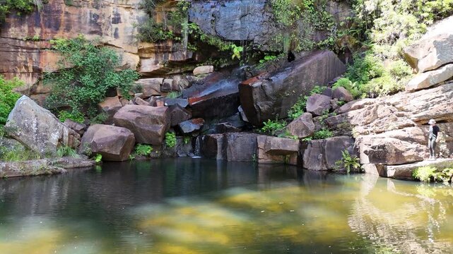 Rainbow Falls Rock pool and cascade waterfall at Blackdown Tablelands, an oasis in the outback and popular travel destination for bush walk and camping in Queensland Australia.