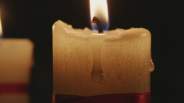 Close-up cinematic footage of church candles burning during Good Friday service symbolizing prayer, hope, and Christian devotion