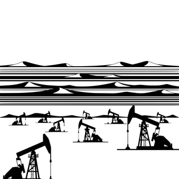 Oil rigs operate beneath striped desert landscape at sunset