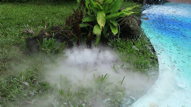 Thick white steam rises from an artificial source as a decorative element in the Kemesraan Park in Pujon, Malang, East Java, Indonesia.