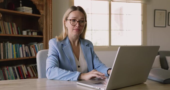 Focused young female freelance professional working from home, typing on laptop, reading email with bad news, getting angry, annoyed, frustrated about problems with application