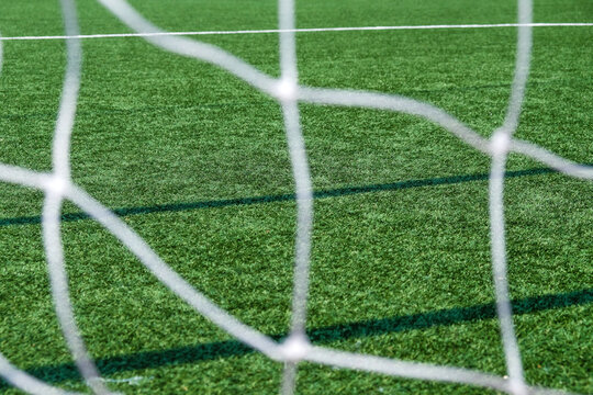Soccer field green grass and net background. Football or soccer field