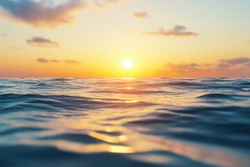 Obraz premium Ocean waves reflecting golden sunlight at sunrise or sunset, creating a peaceful and serene natural seascape