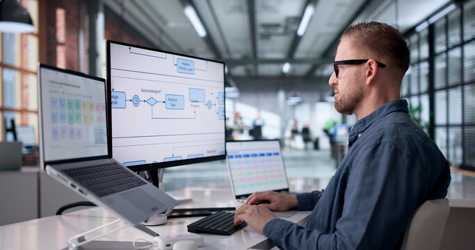 Businessman Analyzes Digital Workflow Chart While Strategizing Work Process