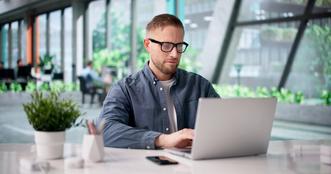 Eco-conscious Business Consultant Researches Green Energy Solutions On Laptop