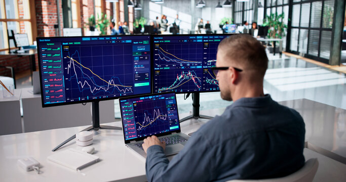 Focused Stock Trader Monitoring Market Trends Across Several