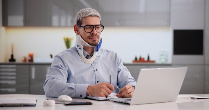 Injured Worker Documenting Accident Report On Laptop
