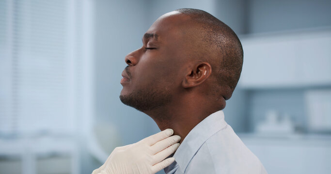 Doctor Carefully Examines A Patient's Neck