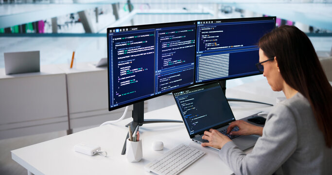Young Woman Developer Writing Code On Laptop
