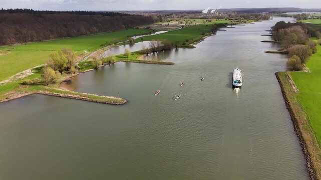 Aerial view of rowing teams training on a wide river