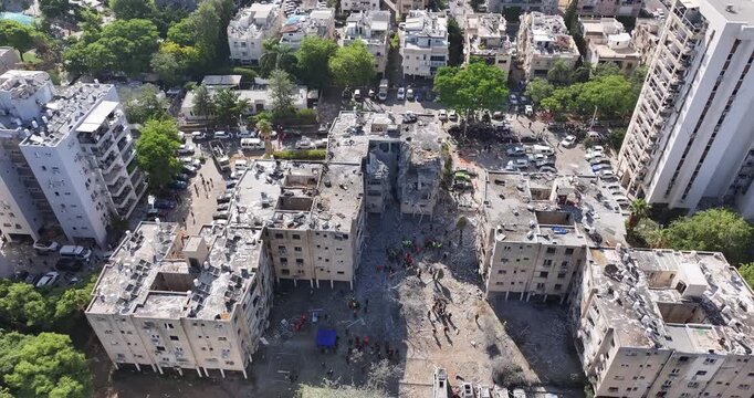 Aerial view Holon Iranian missile strike destruction Israel

Drone footage showing rescue teams at Iranian missile impact site in Holon Israel June 14 2025
