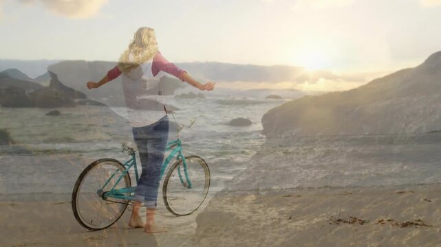 Woman walking shore with turquoise bicycle, sunset drawing her as dissolve ghosting for health