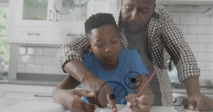 Father guiding son at counter, placing arm, pointing, helping with education, overlay showing paper