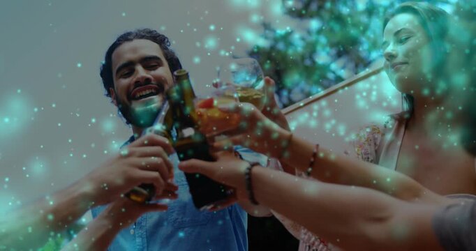 Hands reaching and clinking bottles and glass, friends toasting outside with teal sparkles drifting