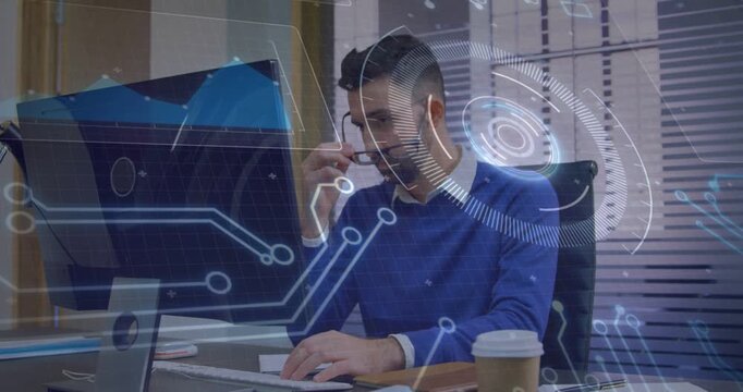 Tech analyst typing on keys, driving HUD updates on monitor while adjusting glasses, reviewing data