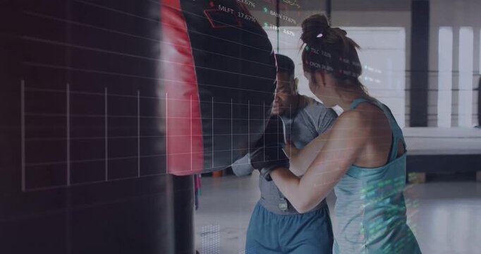 Coach timing boxing drill guiding trainee practicing combos on heavy bag, data overlaying trainee