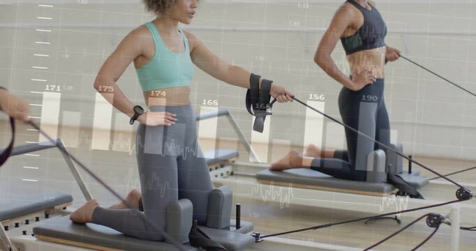Hand gripping strap initiating two women kneeling on reformer pulling while charts tracking fitness